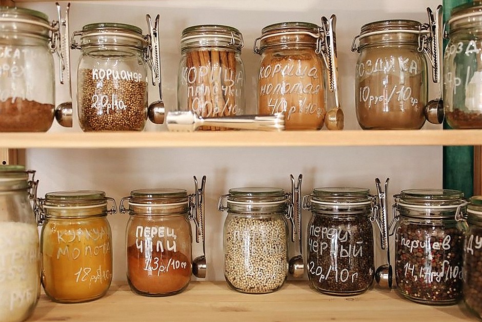 Labeled pantry jars on open wooden shelves