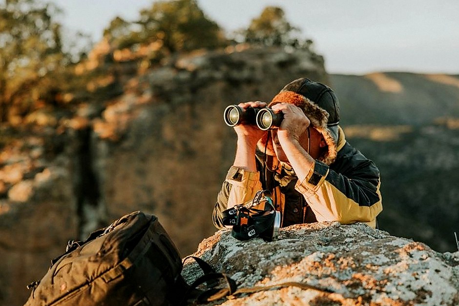Photographer using a camera during a rocky landscape walk
